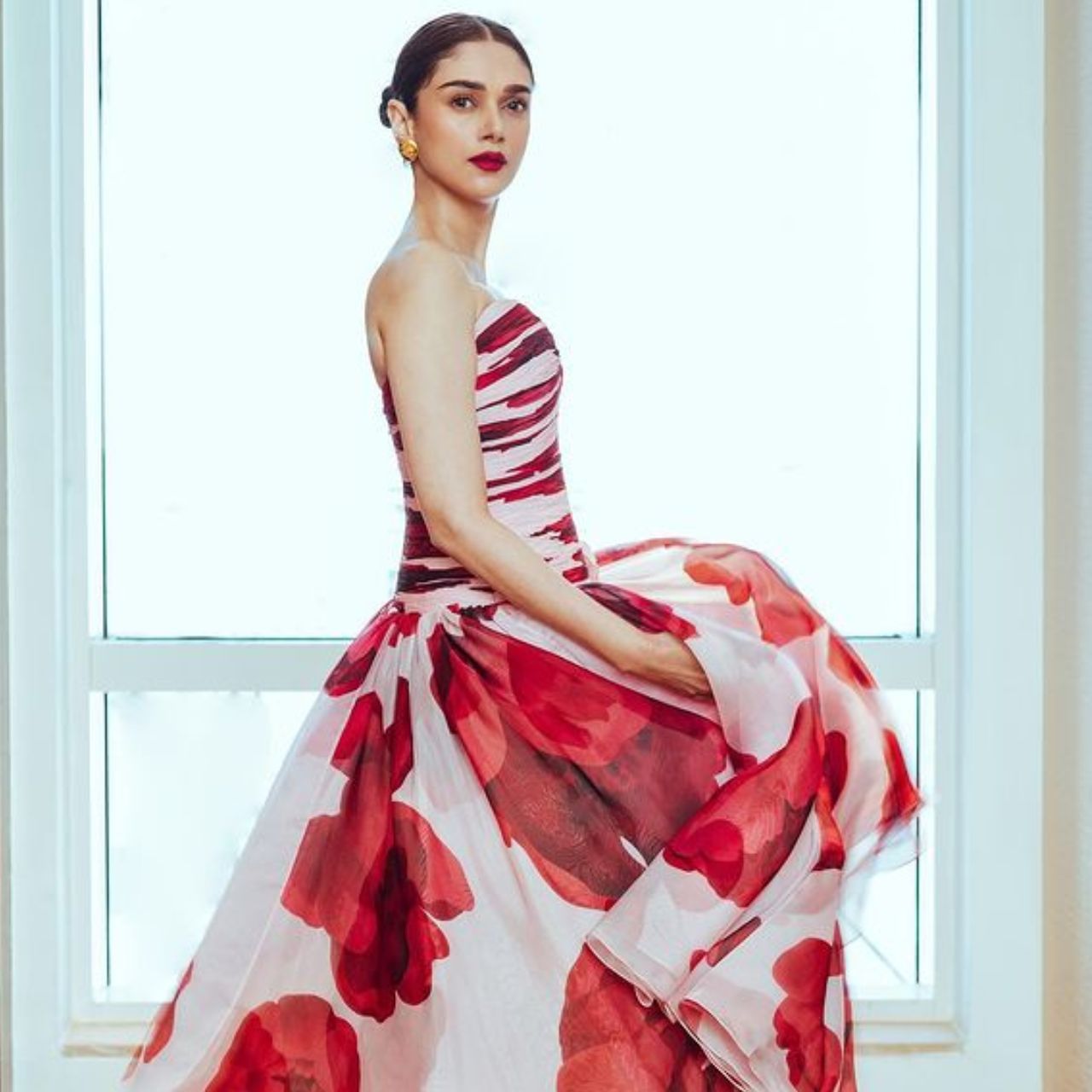 Her style is looking very hot even in an off shoulder floral gown.  The actress has carried a sleek bun hairstyle.  Her minimal makeup looks fabulous on the gown look. 