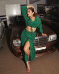 Photo by Huma Qureshi on June 20 2023. May be an image of 1 person makeup fishnet stockings miniskirt dress limousine headscarf and text